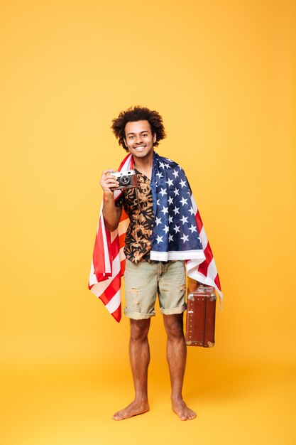 Full length portrait of a smiling african man tourist