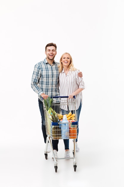 Full length portrait of a smiling couple standing