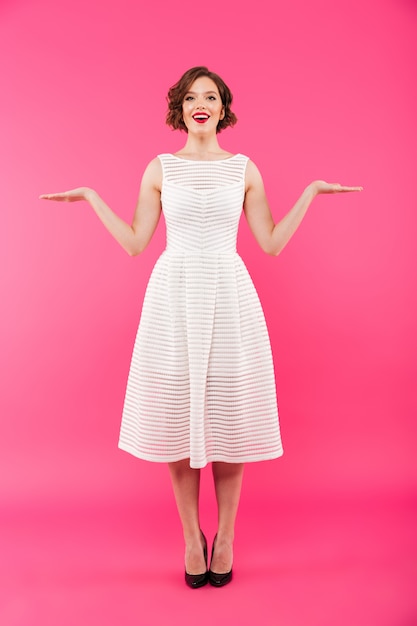 Full length portrait of a smiling girl dressed in dress