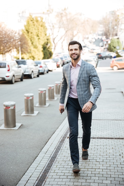 Full length portrait of a smiling handsome man in jacket