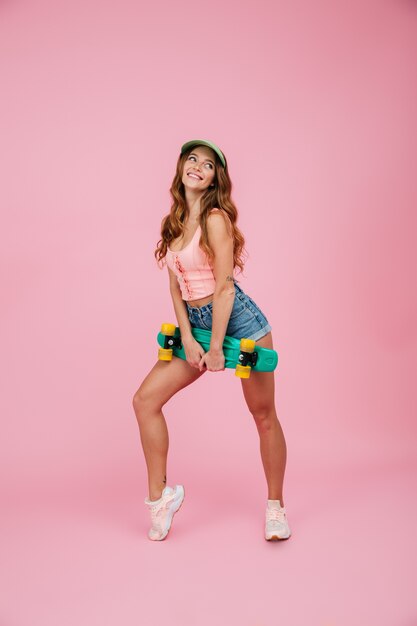 Full length portrait of a smiling woman in summer clothes