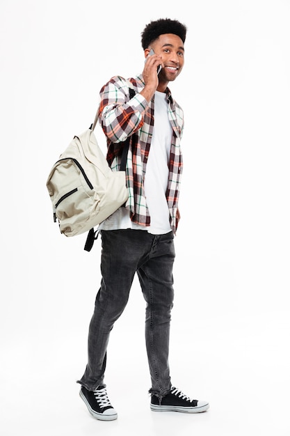 Free photo full length portrait of a smiling young african male student