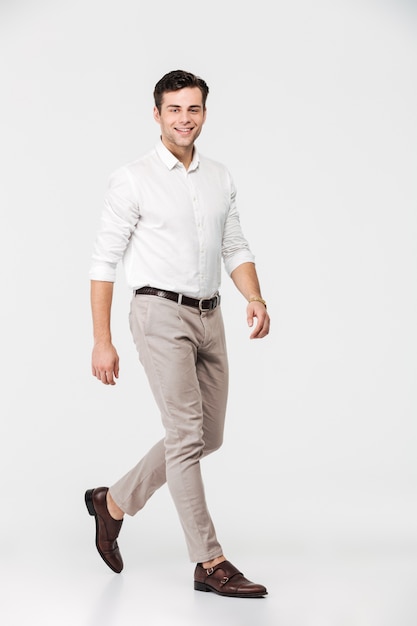 Full length portrait of a smiling young man