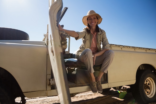 Free photo full length portrait of woman sitting in vehicle