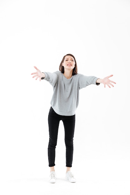 Free photo full length portrait of a woman standing with outstretched hands