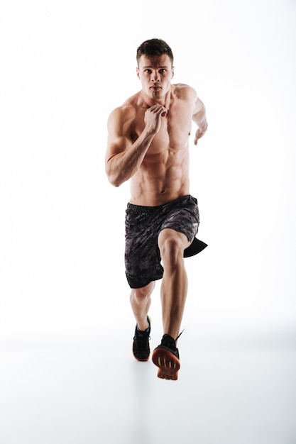 Full length portrait of young attractive runner in motion