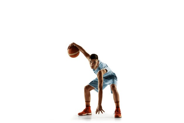 Full length portrait of young basketball player with a ball isolated on white