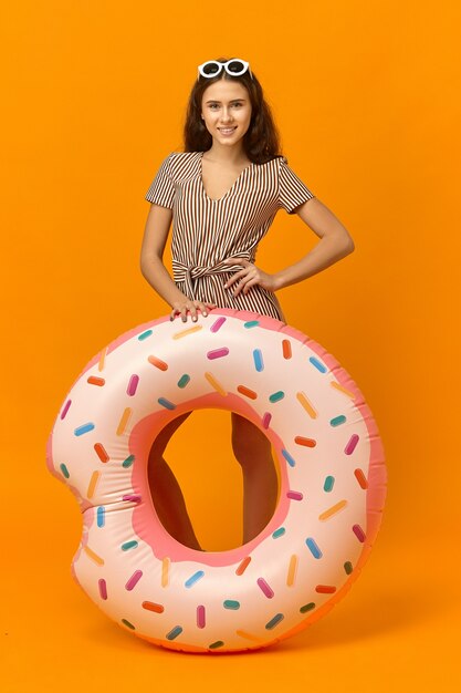 Full length shot of positive joyful young woman with tanned skin and long loose hair