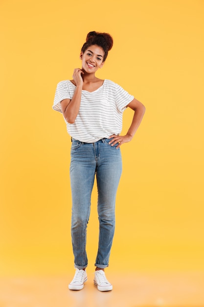 Full-length shot of pretty african lady smiling isolated