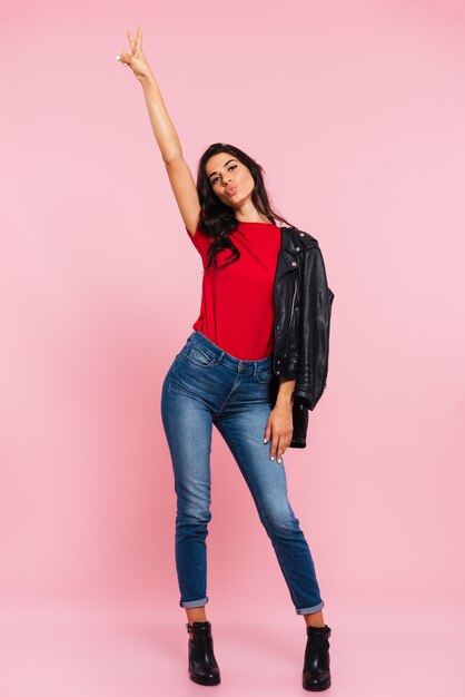 Full-length shot of tall brunette caucasian lady standing isolated