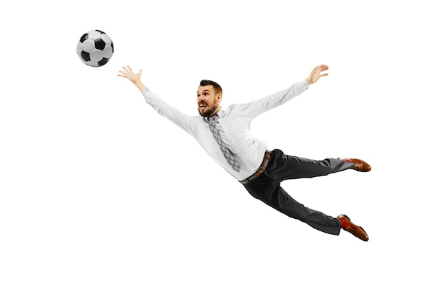 Full length shot of a young businessman playing football isolated on white background.