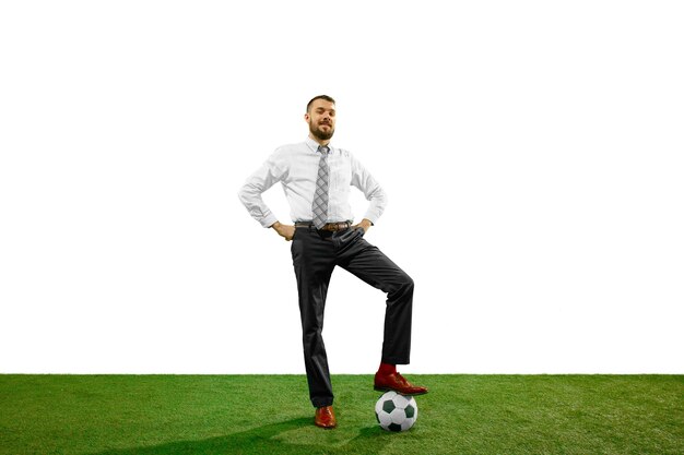 Full length shot of a young businessman playing football isolated on white background.