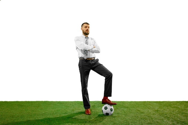 Full length shot of a young businessman playing football isolated on white background.