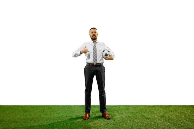 Full length shot of a young businessman playing football isolated on white background.