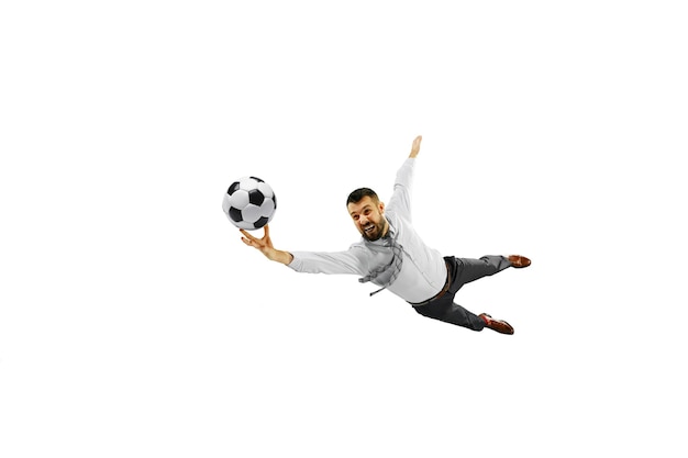 Full length shot of a young businessman playing football isolated on white wall