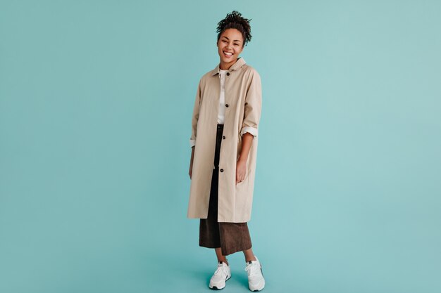 Full length view of adorable woman in trench coat