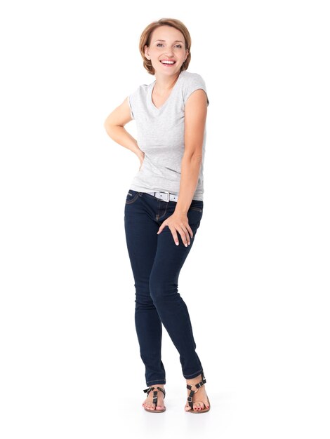 Full portrait of the beautiful happy woman stands on white