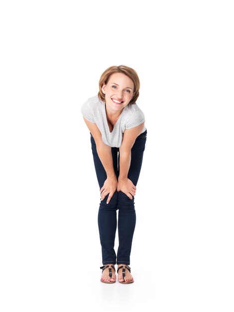 Full portrait of the beautiful happy woman stands on white