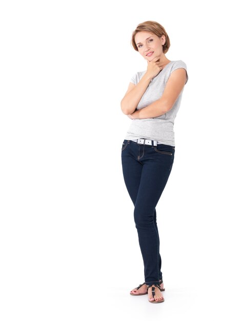 Full portrait of the beautiful thinking woman stands on white