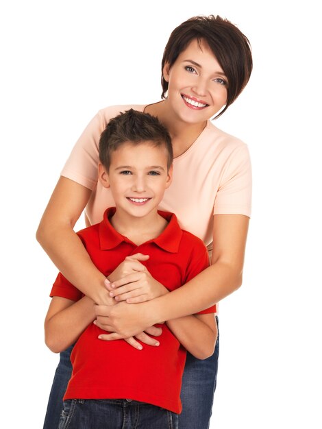 Full portrait of a happy young mother with son 8 year old over white wall