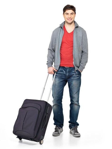 Full portrait of smiling happy man with grey suitcase isolated on white