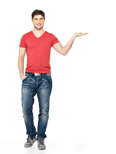 Full portrait of a smiling man holds something on palm  isolated on white background.