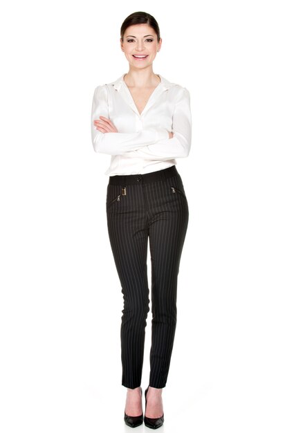 Full portrait of young  beautiful woman  in white shirt and black trousers  standing . 
