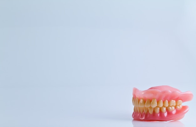 full set of acrylic denture isolated on white background