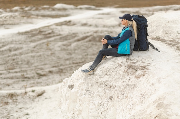 Full shot adult traveler out in the nature