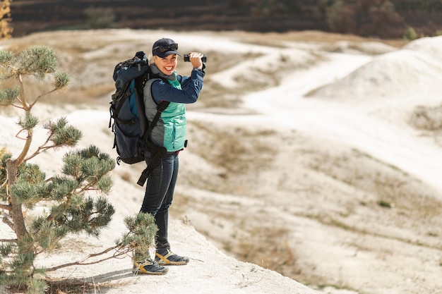 Full shot adult traveler with backpack