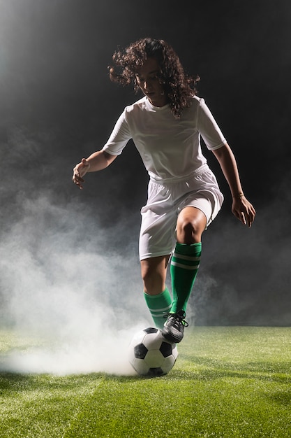 Full shot adult woman with soccer ball