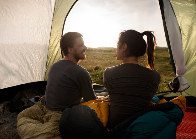 Full shot adventurous couple bivouacking