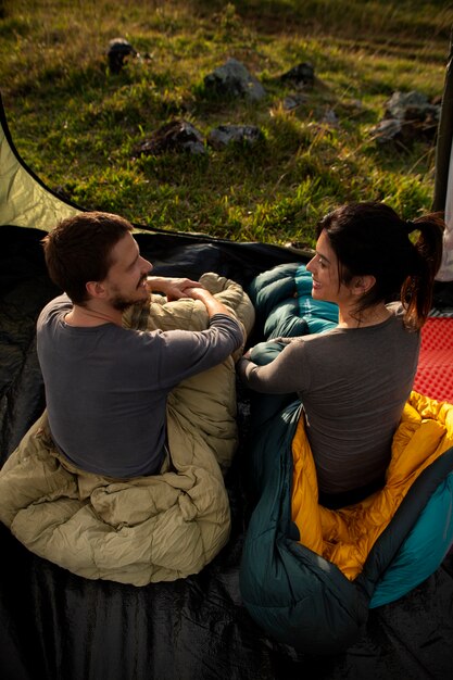 Full shot adventurous couple bivouacking