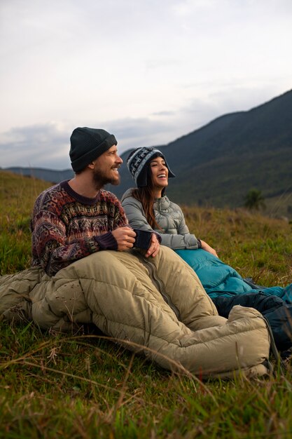 full shot adventurous couple bivouacking