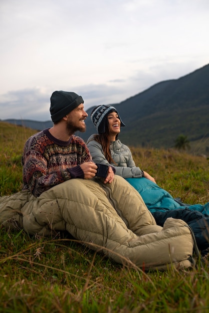 Full shot adventurous couple bivouacking