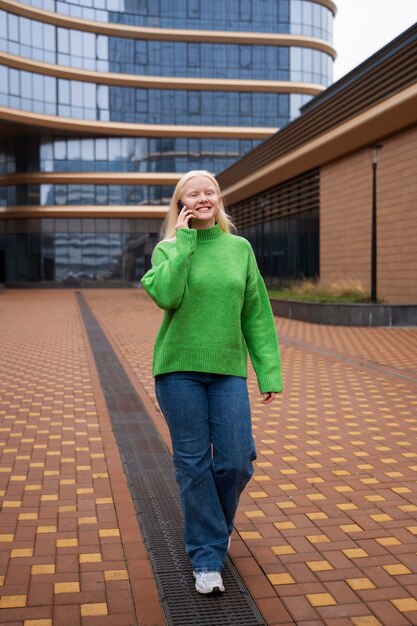 Full shot albino woman talking on phone