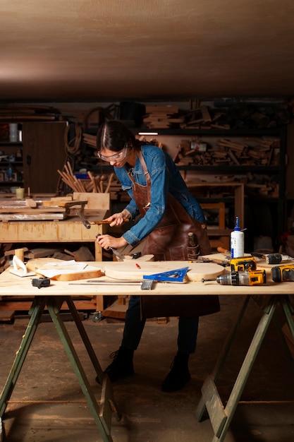 Free photo full shot artisan doing woodcutting