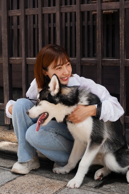 Free photo full shot asian woman with cute dog