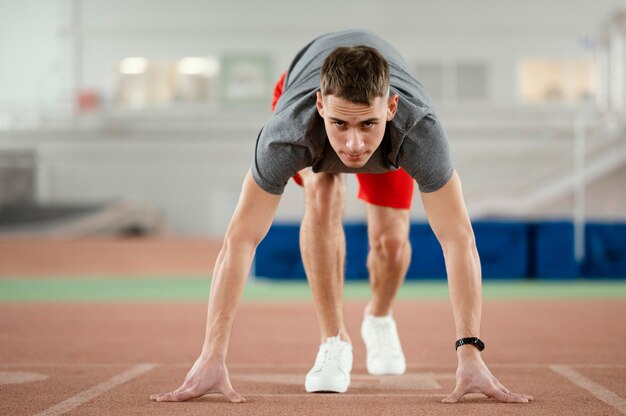 Full shot athlete ready to run