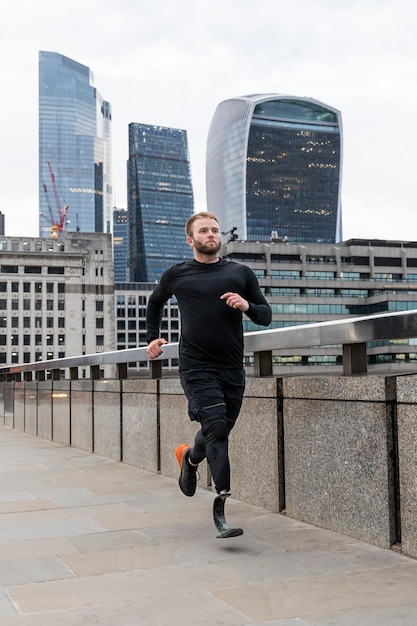 Full shot athlete running with prosthetic leg