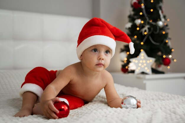 Full shot baby holding decorations