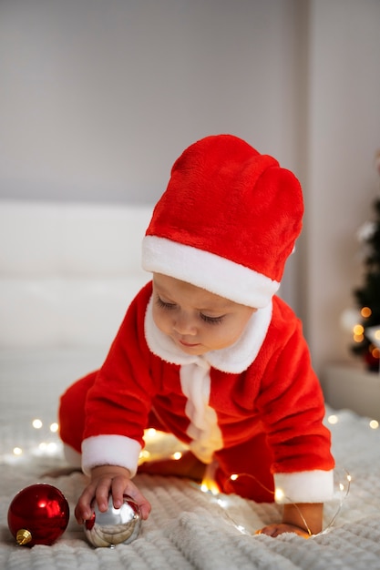 Full shot baby wearing santa outfit