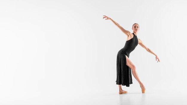 Full shot ballerina dancing with copy-space