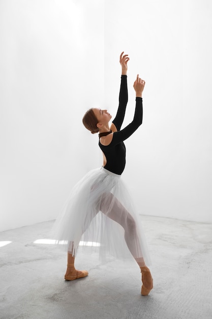 Free photo full shot ballerina posing in studio