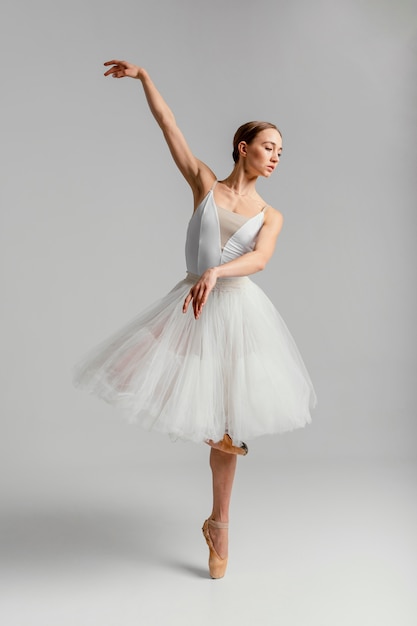 Free photo full shot ballerina standing with pointe shoes