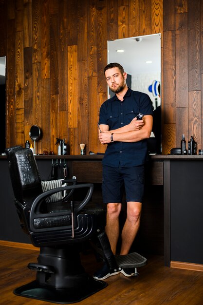 Full shot of barber at hair salon