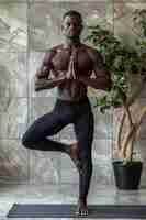 Free photo full shot black man practising yoga