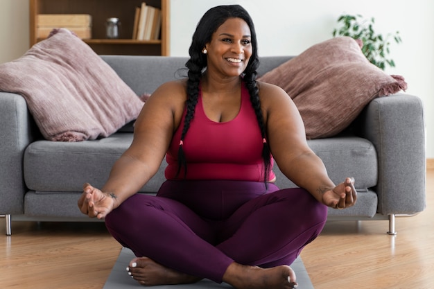 Full shot black woman relaxing at home