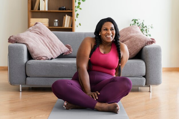 Full shot black woman relaxing at home