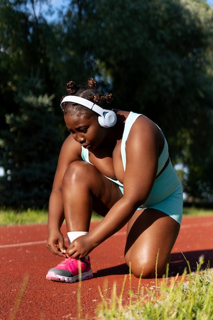 Full shot black woman training outdoors